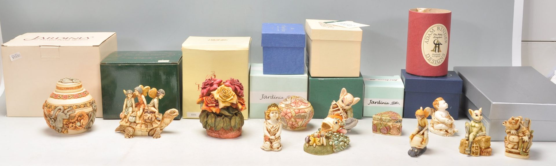 A mixed group of twelve carved resin figures / trinket pots to include examples from Harmony Garden,