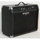 A Behringer V-ampire LX210 electric guitar amplifier having a digital display window, leather finish