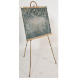 A vintage retro 1950's school black board having alphabet letters, a clock with moveable hand and