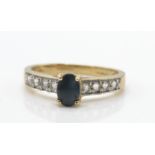 A 9ct gold, sapphire and diamond ring. The ring set with cabochon sapphire with diamond set