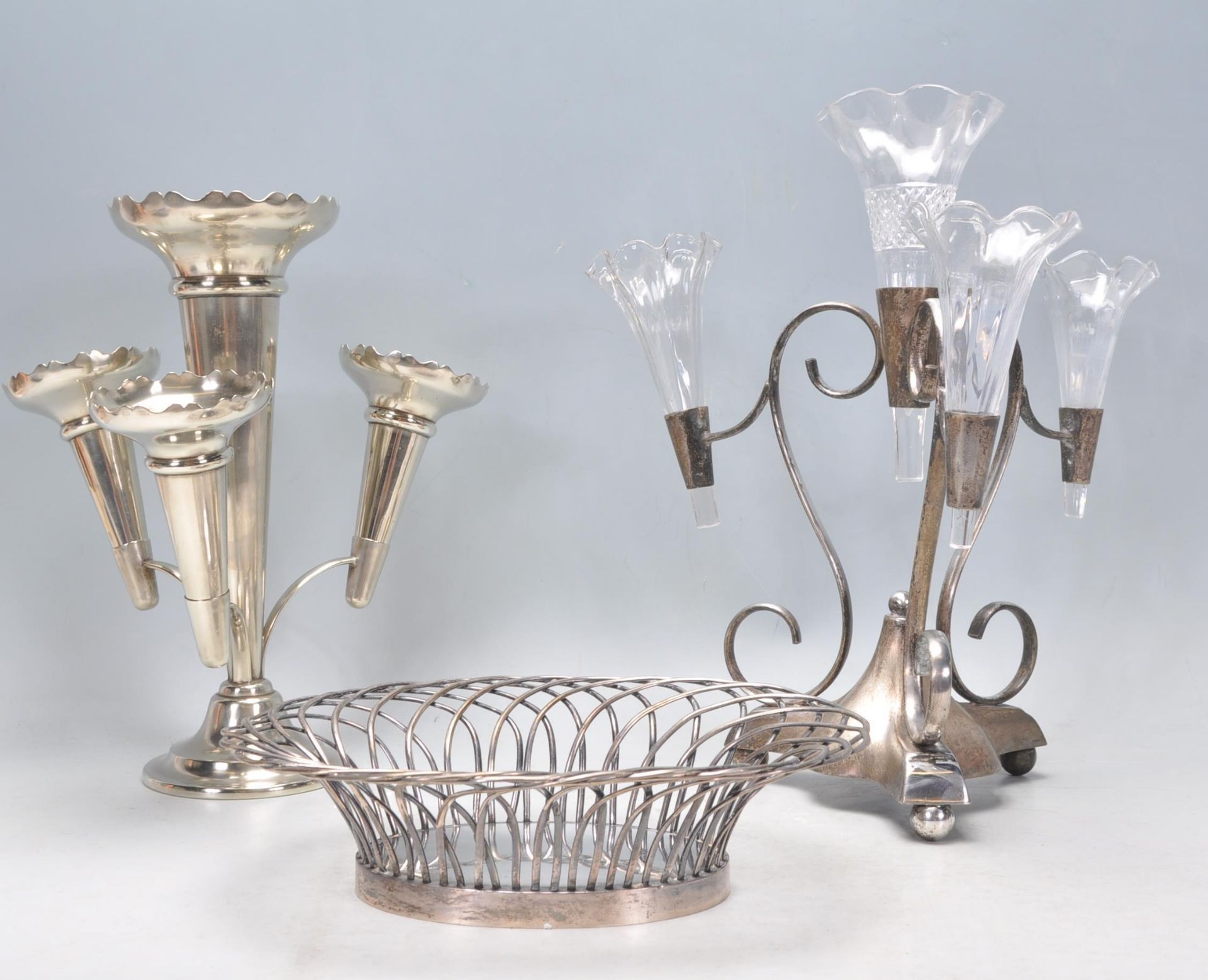 Two 20th Century silver plated table centerpiece epergnes to include one of tripod form with three