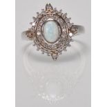 A stamped 925 silver panel ring having a central oval opal with concentric halo's of CZ's. Weight