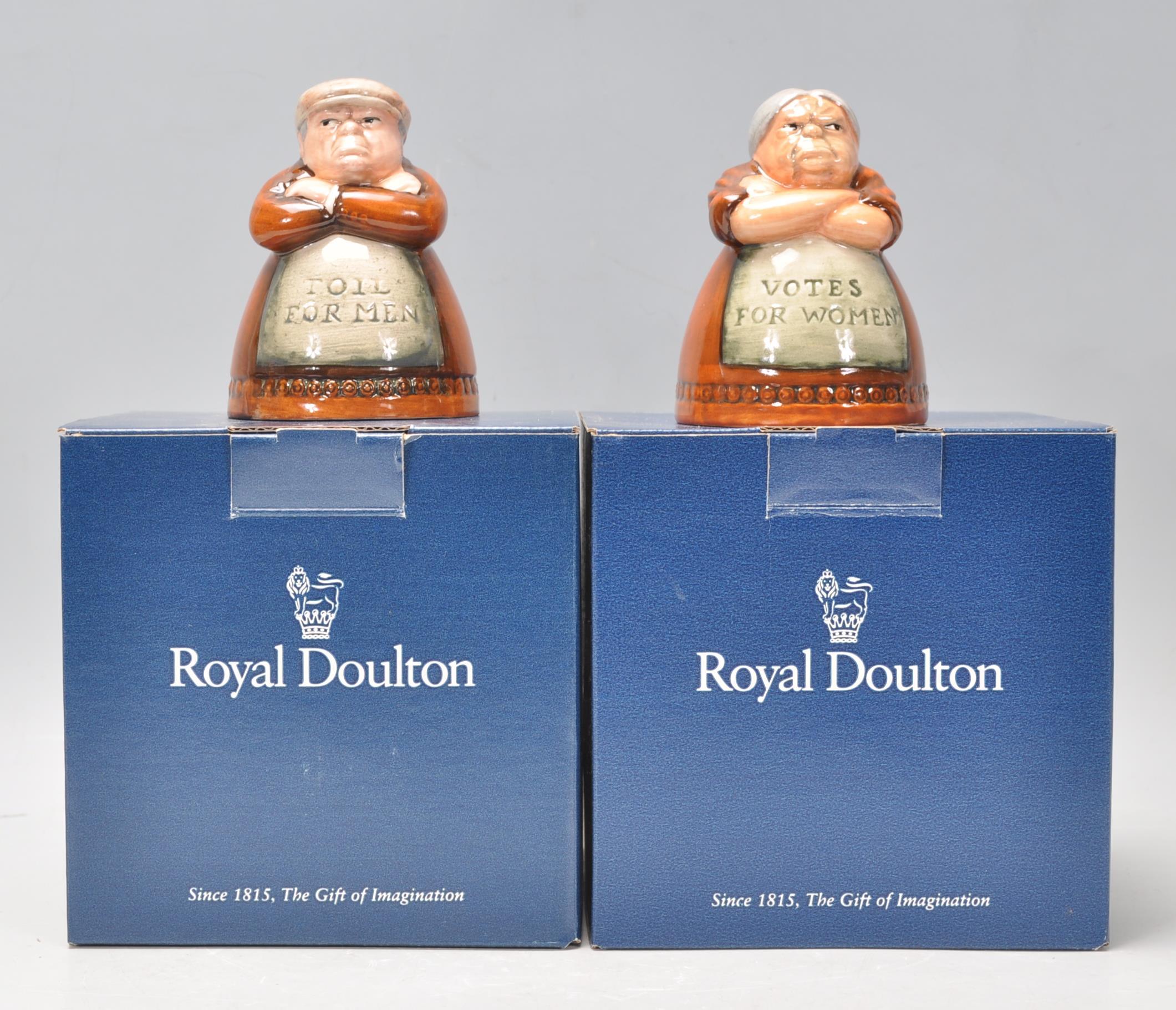 A pair of Royal Doulton salt and pepper pots entitled 'Votes for Women' and 'Toil for Men', D7066