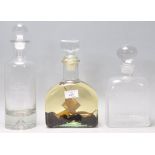 A vintage retro Danish glass decanter together with 2 other clear glass decanters, one marked for