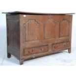 A Georgian 18th century country oak mule chest with a hinged double plank lift top having a three