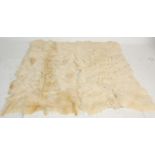 Two large 20th century retro sheepskin floor rugs of natural form. H169 W80cm