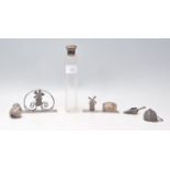 A group of silver items to include a silver topped scent bottle with a faceted glass bottle (