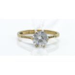A hallmarked 9ct gold and white stone solitaire ring. The ring set with a mixed cut white stone with