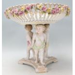 A 19th Century German tazza in the manner of Meissen having a round bowl hand painted with roses and