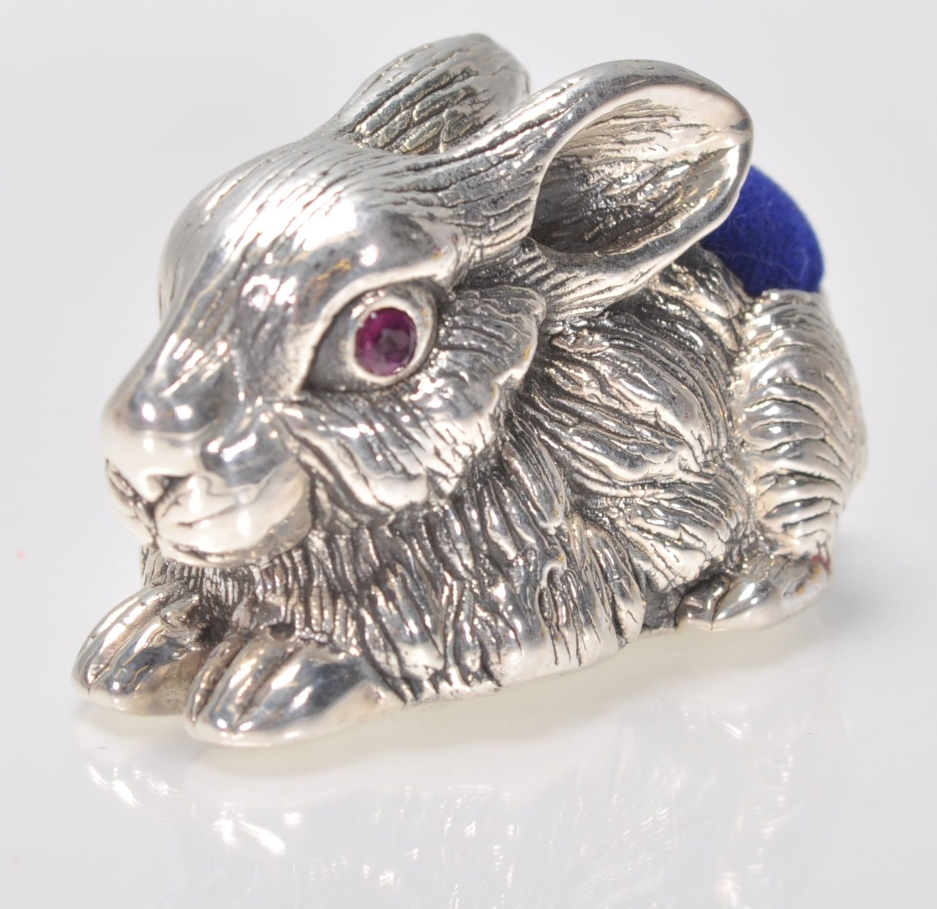 A stamped 925 silver cushion in the form of a hare / rabbit having a blue velvet cushion to the back