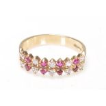 A 9ct gold ruby and diamond 18 stone ring. The ring with prong mounted rows of rubies and