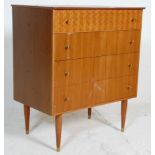 A vintage retro mid 20th Century Uniflex teak wood chest of four drawers being raised on tapering