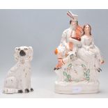 A 19th Century Victorian Staffordshire figurine in the form a Scottish kilted bagpipe player and a