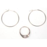 A pair of stamped 925 silver hoop earrings together with a silver cross over design ring set with