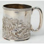 A late 19th Century Victorian silver hallmarked mug having repousse decoration depicting a