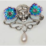 A stamped 925 silver Art Nouveau style brooch having a female face flanked by two plique a jour