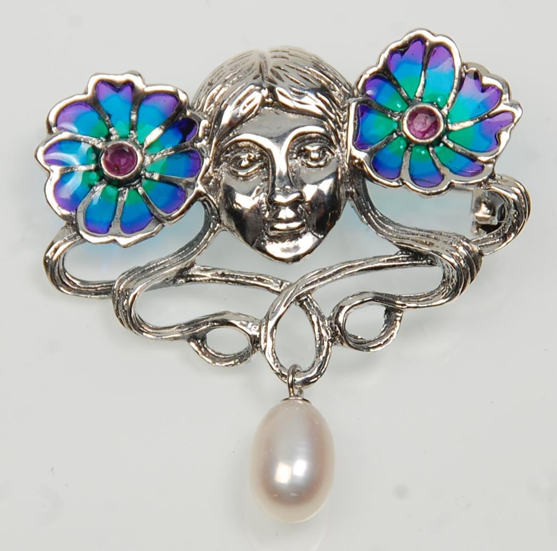 A stamped 925 silver Art Nouveau style brooch having a female face flanked by two plique a jour