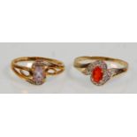 Two 9ct yellow gold ladies dress rings. One set with a central orange oval faceted cut stone with