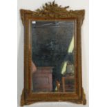 A 19th Century French wall mirror having a moulded gilt frame having raised floral and foliate