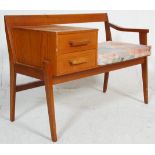 A vintage retro mid 20th Century telephone seat having a bench seat raised on square supports with a