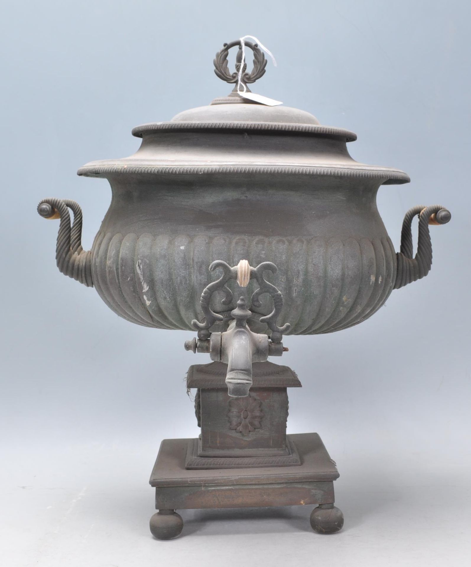 A 19th Century Victorian samovar having a reeded body with twin turned bone handles, raised on a