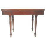 A 19th Century mahogany card / tea table having a folding and revolving top with brass fittings