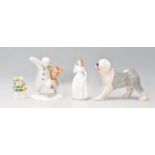 A group of four Royal Doulton figurines to include the snowman and James dancing in the snow (