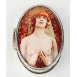 A stamped 925 silver pill box of oval form having an enamelled panel depicting a semi nude woman.