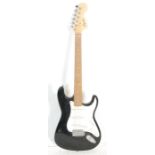 A Squier Strat by Fender Affinity Series Stratocaster electric guitar having a black body with white