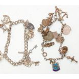 Two silver charm bracelets adorned with many charms. One vintage example having tourist shield