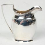 A good late 18th Century George III silver hallmarked jug having a banded rim with shaped angular