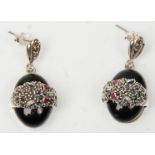 A pair of stamped 925 silver drop earrings in the form of leopards upon black onyx stones, set