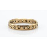 A 9ct gold full eternity ring. The ring inset with white stones to shaped band. Total weight 2.