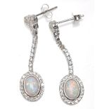 A pair of ladies silver drop earrings set with oval opal panels and CZ's. Weight 4g. Measures 3.