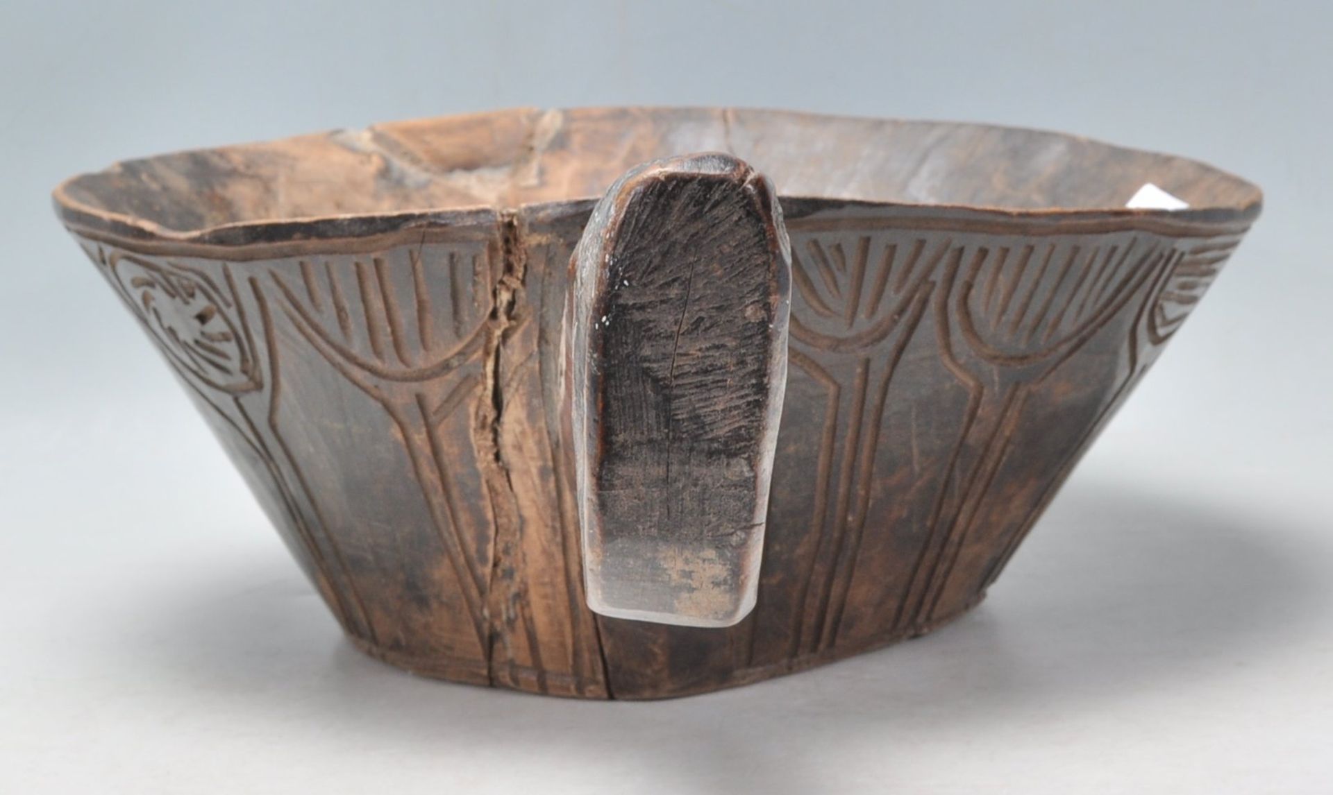 A antique African carved hardwood tribal bowl of conical form having a large carved handle to one - Bild 4 aus 6