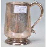 A 20th Century stamped sterling silver tankard of tapering cylindrical form raised on a footed