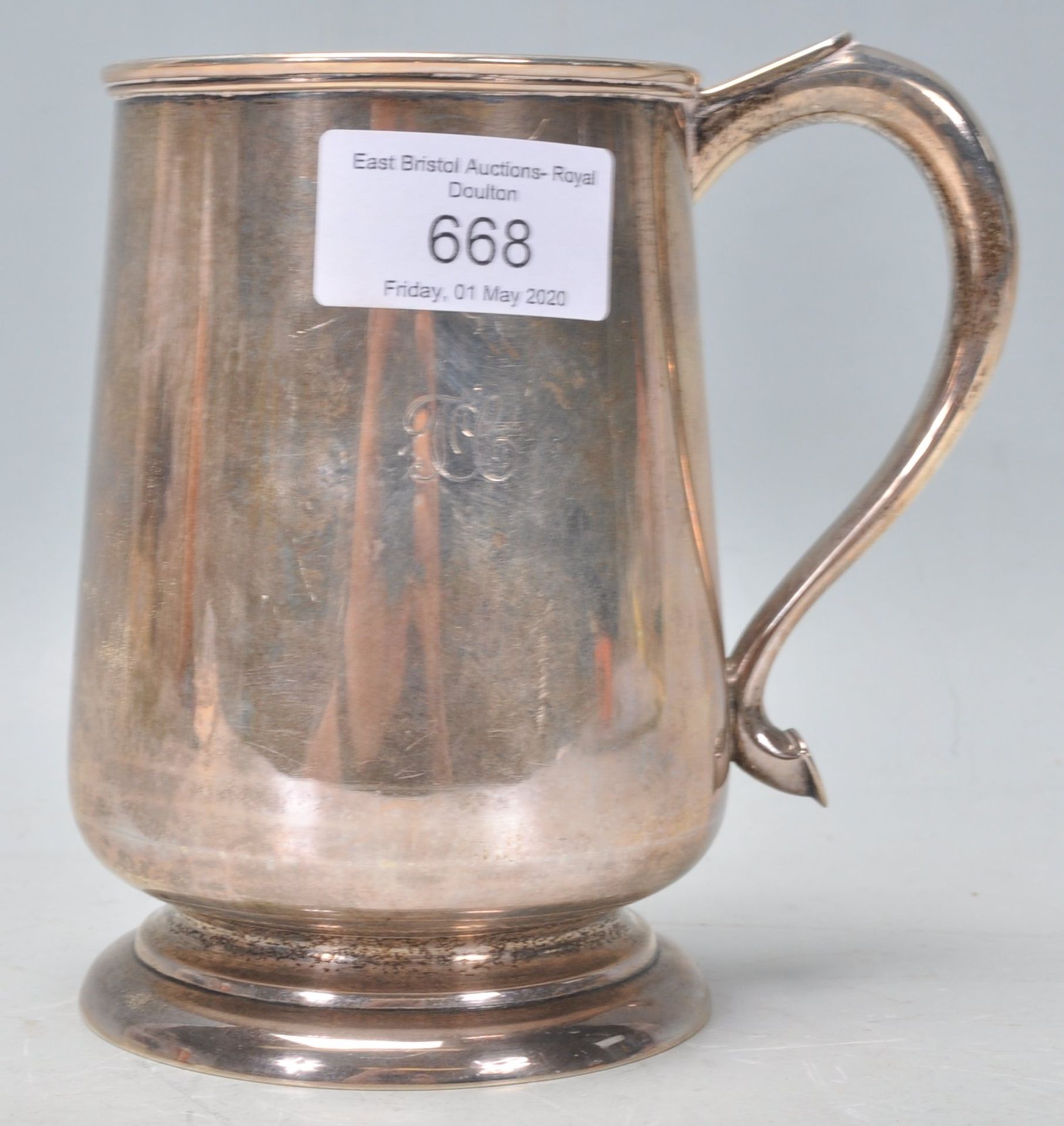 A 20th Century stamped sterling silver tankard of tapering cylindrical form raised on a footed