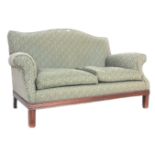 A 20th Century Howard Style upholstered two seater sofa settee having a shaped back with rolled