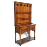 A good Georgian revival oak dresser. Of good small proportions, the base having an open recess