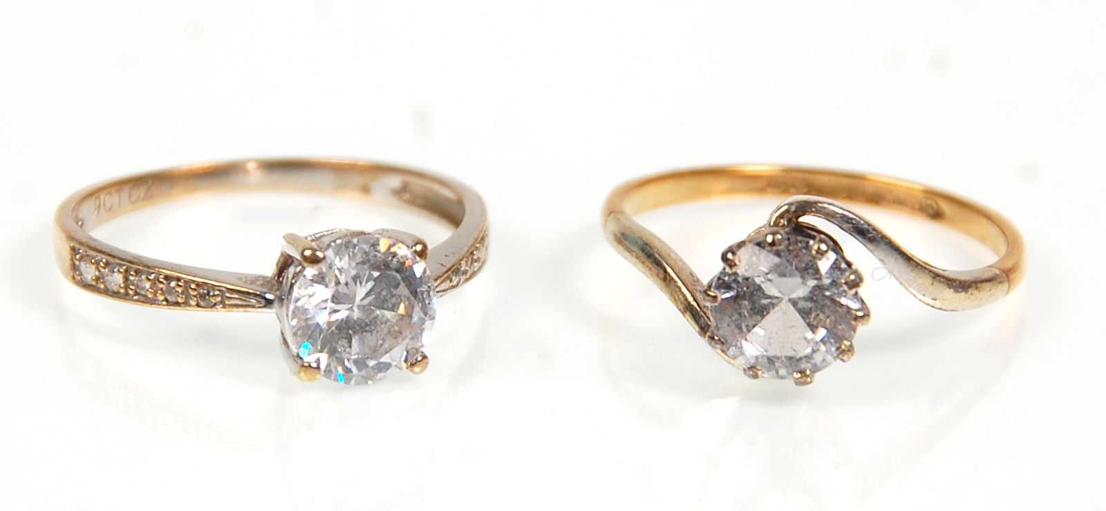 Two 9ct gold ladies rings. One set with a large single CZ stone to the center with white accent