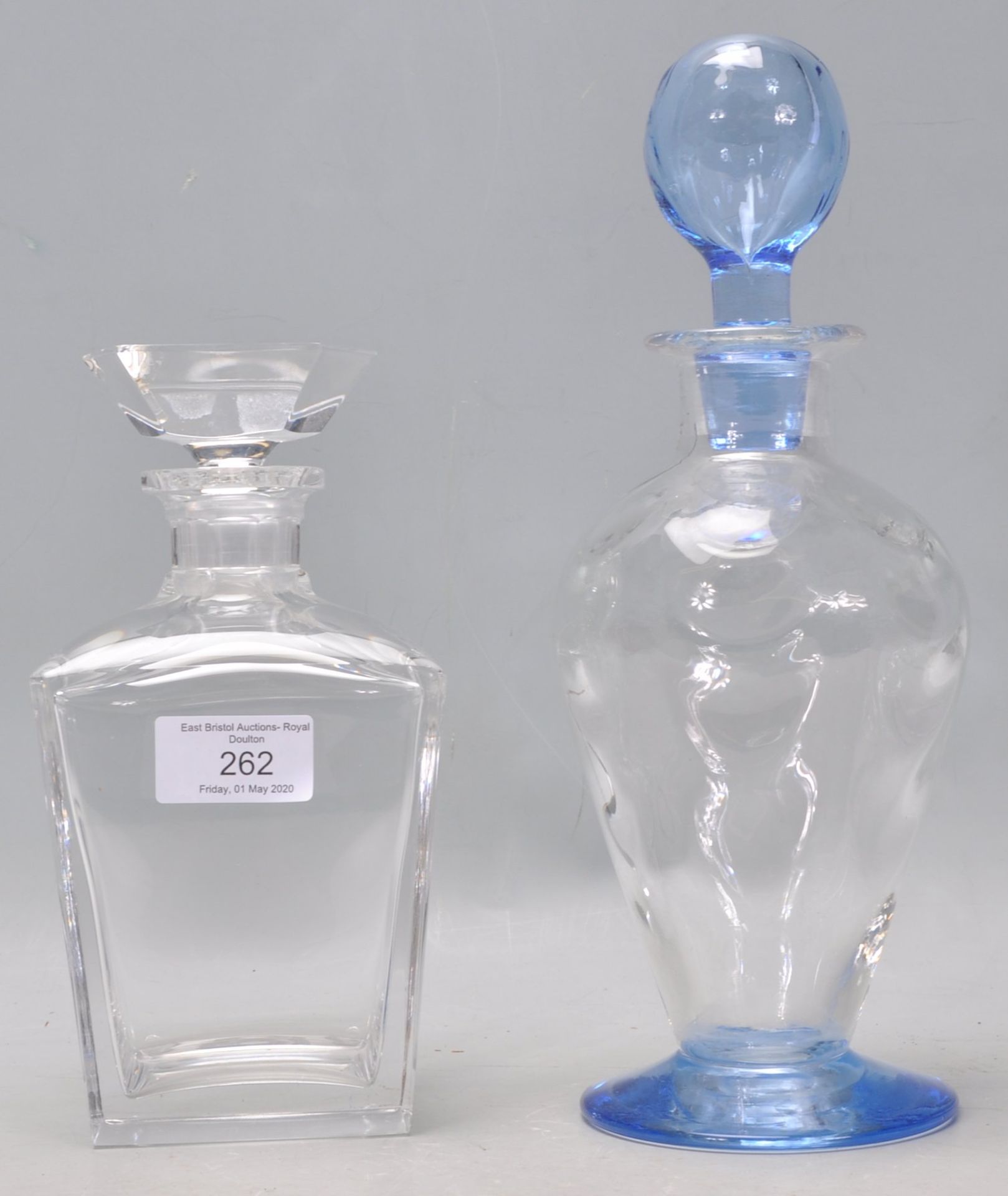 Two vintage 20th Century glass decanters to include a blue glass bottle decanter with a bulbous form