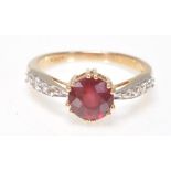 A 9ct gold  Birmingham hallmarked red and white stone ring. The large round cut red stone with white