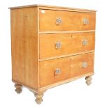 A Victorian pine cottage small chest of drawers being raised on bun feet with glass handles to the 3
