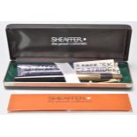 A vintage Sheaffer fountain ink pen in its original box with paper work, having a black plastic