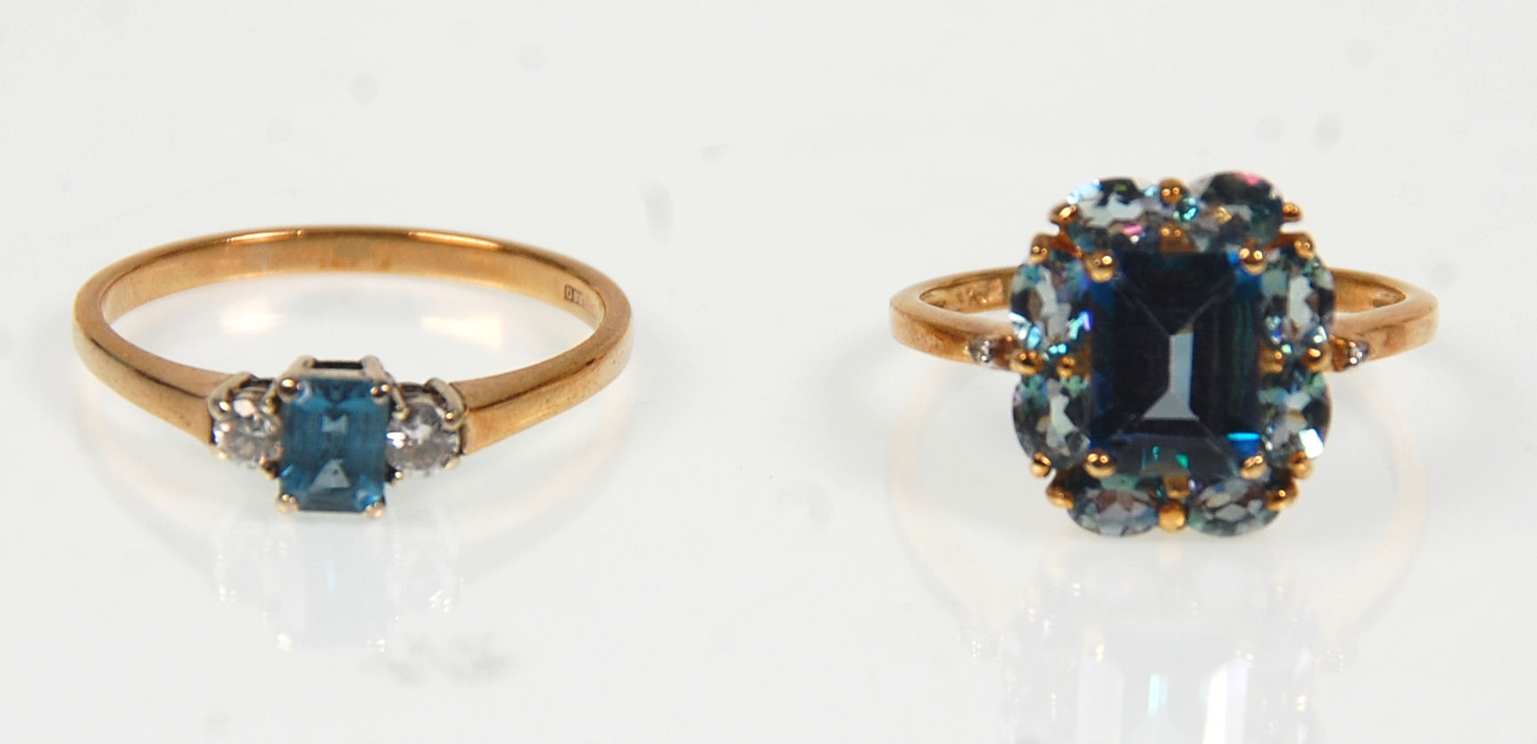 Two 9ct yellow ladies dress rings. One set with a large square faceted cut blue stone surround by