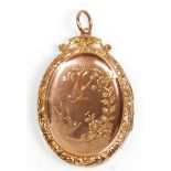A vintage 9ct yellow gold back and front locket pendant of oval form having engraved swallow
