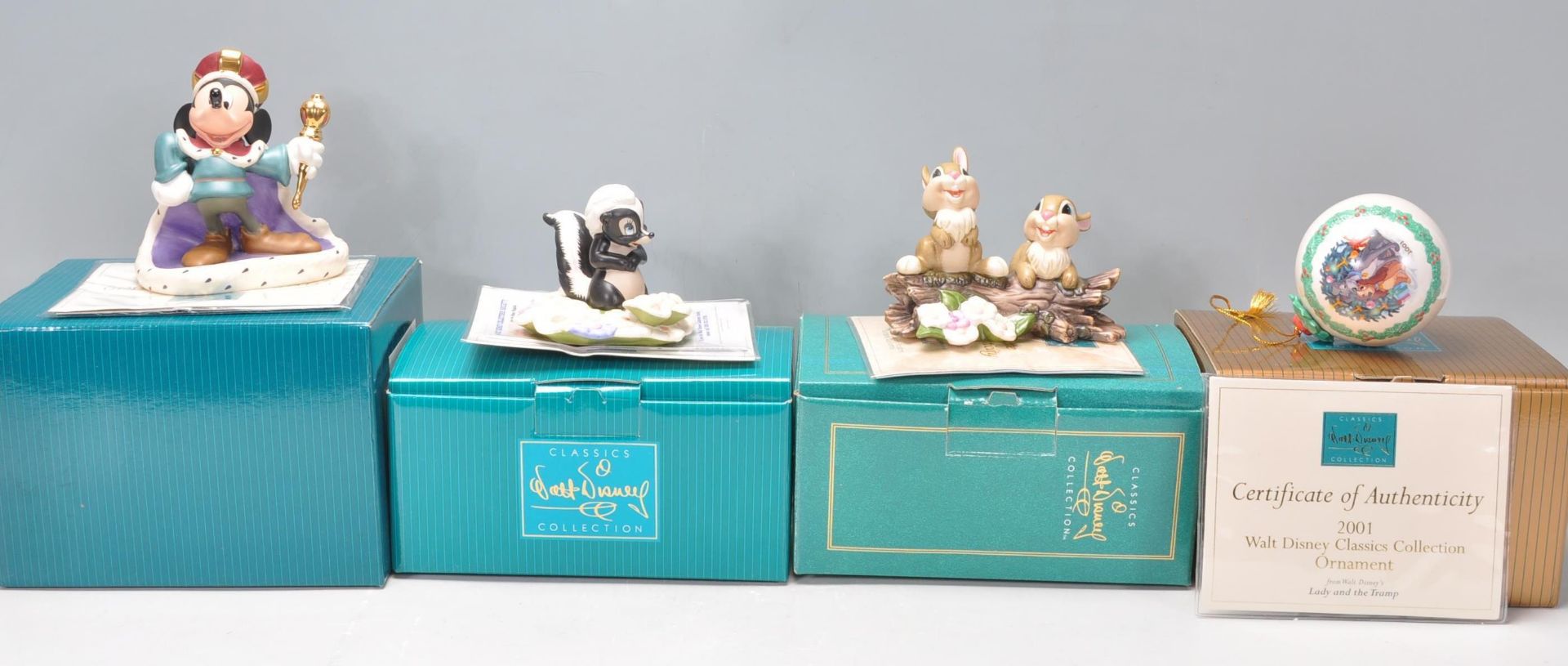 A group of four Walt Disney Collection figurines to include Mickey Mouse; Long Live the King, Bambi;