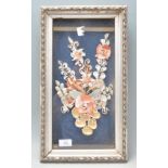 A lovely collection of framed and glazed shells forming a decorative flower of varying colors.