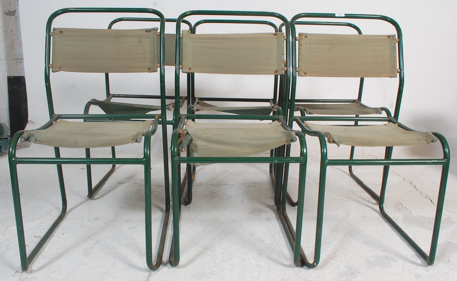 A group of six 20th Century vintage industrial military style tubular framed chairs having green