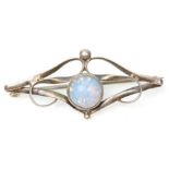 An early 20th Century Art Nouveau silver brooch set with a central opal panel within an openwork